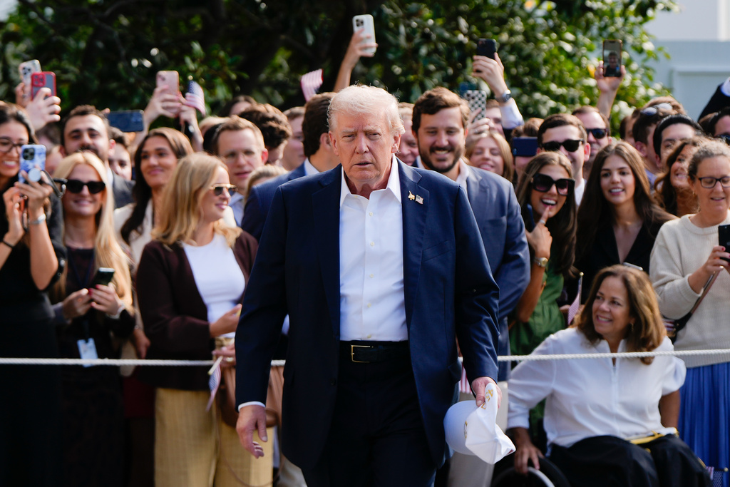 President Donald Trump walks to speak with reporters after greeting supporters before departing the White House, Friday, Sept. 26, 2025, in Washington. (AP)